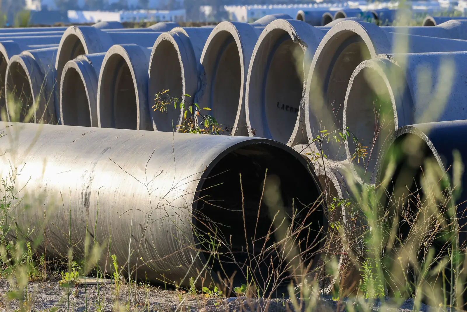 Close-up of circular concrete pipe segments used in underground tank and drainage construction