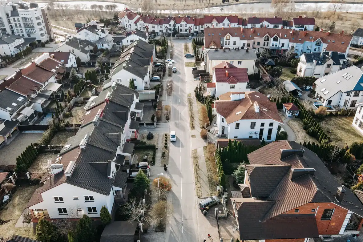 Aerial view of a suburban neighborhood street lined with houses